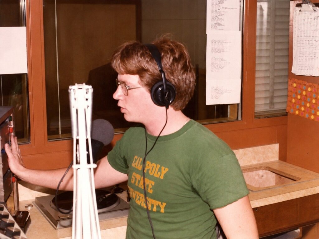 KCPR DJ pressing a cart machine button while on the air