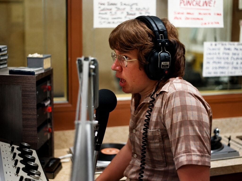 KCPR DJ at the microphone with a turntable and control equipment nearby