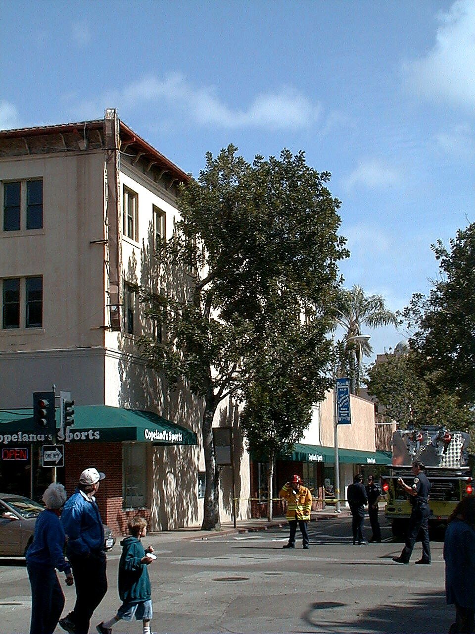 Firefighters and pedestrians near the Wineman Hotel building during the sign incident, April 1999
