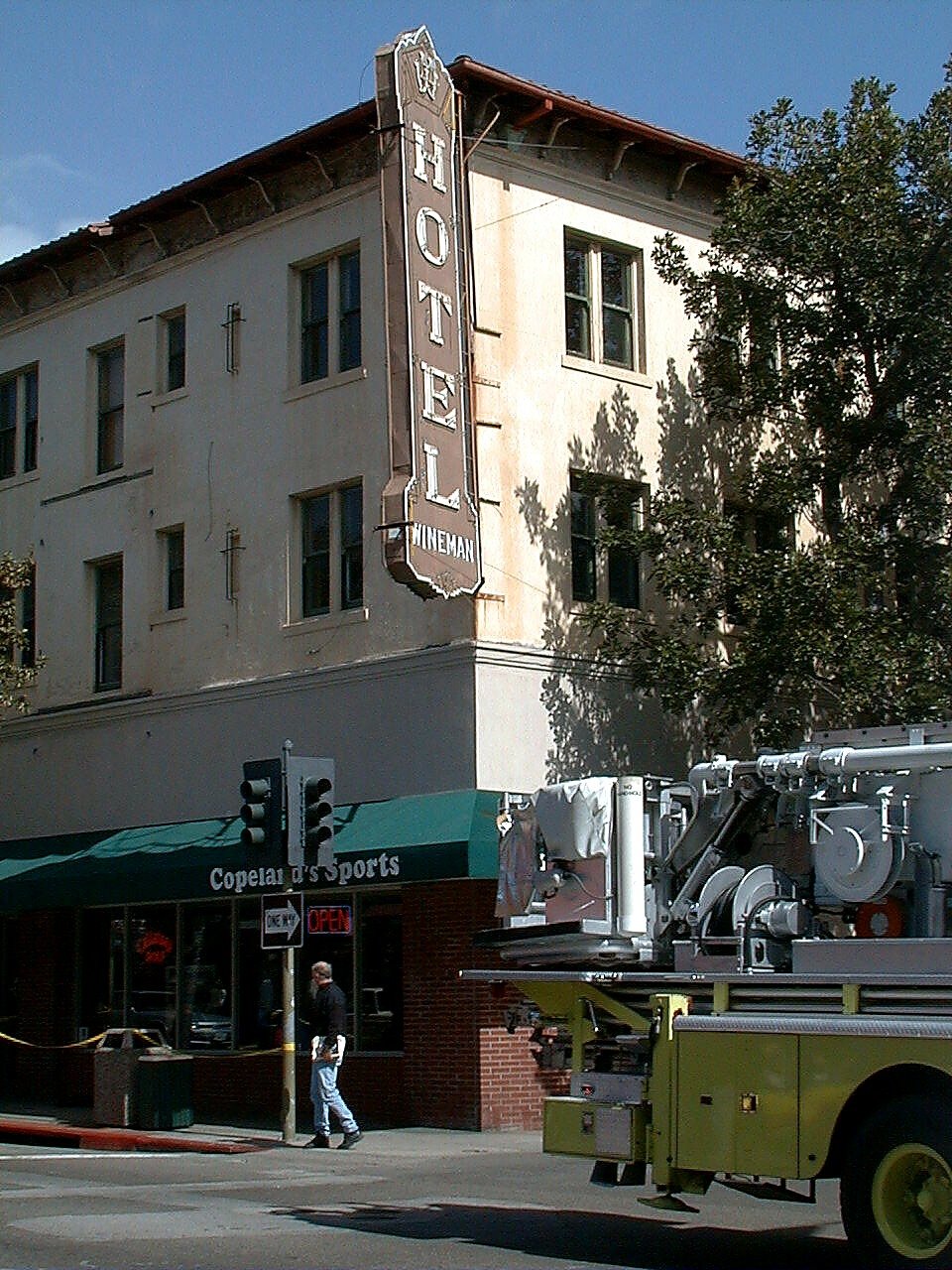 A man walking beneath the Wineman Hotel sign during the April 1999 incident in downtown San Luis Obispo