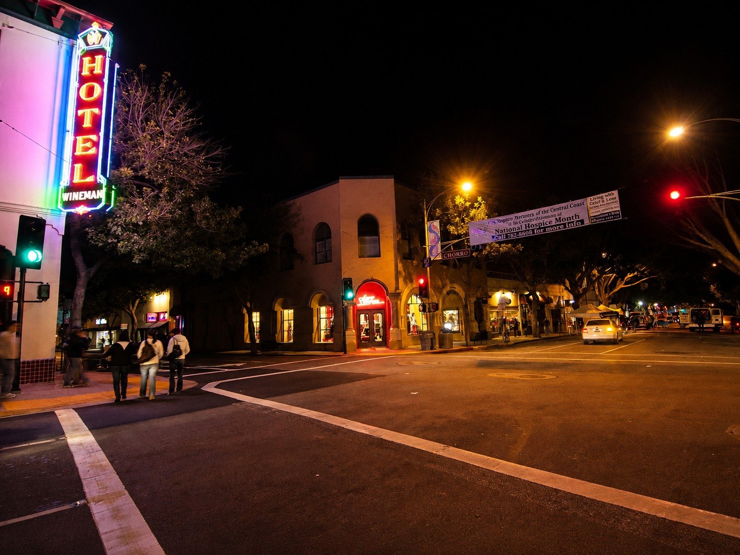 The restored Wineman Hotel neon sign illuminated at night at Higuera and Chorro in downtown San Luis Obispo